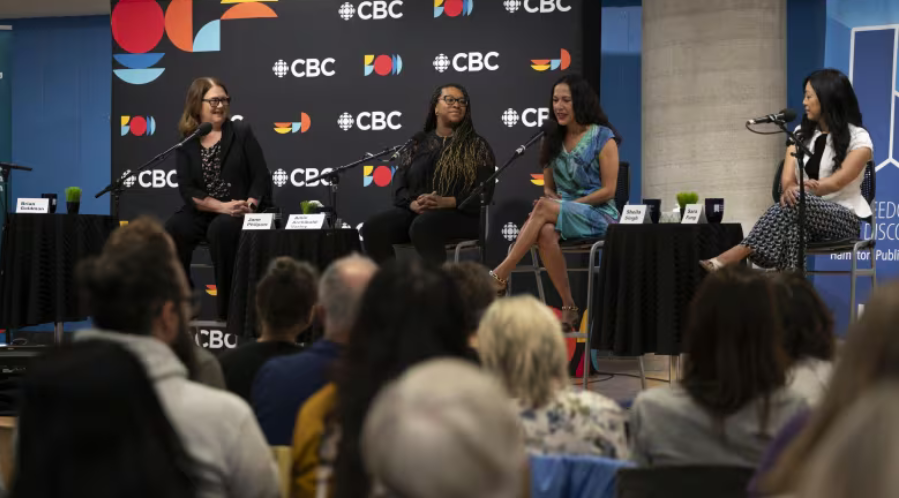 People sitting on chairs on a panel