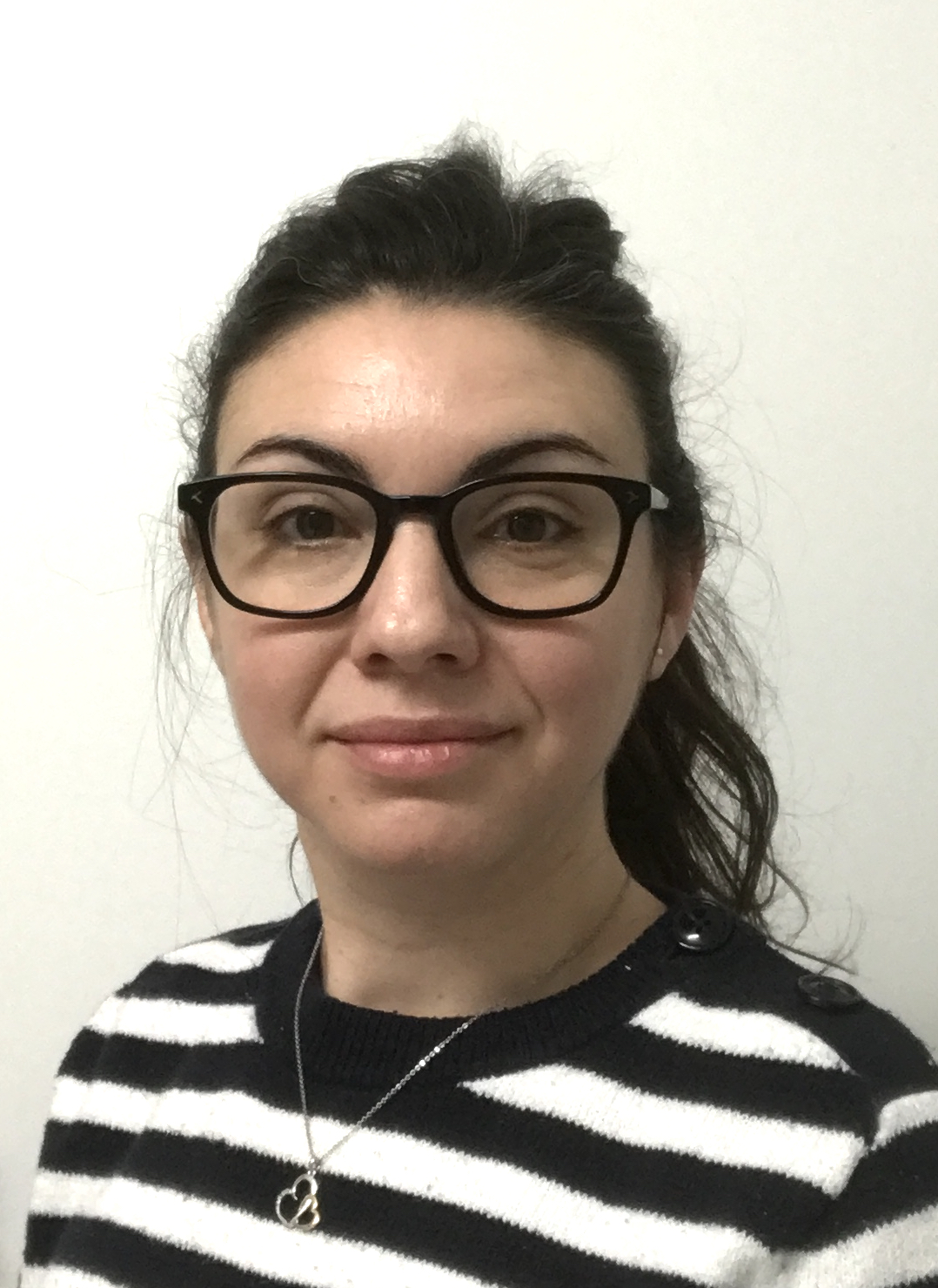 Person in glasses and striped shirt on a white background